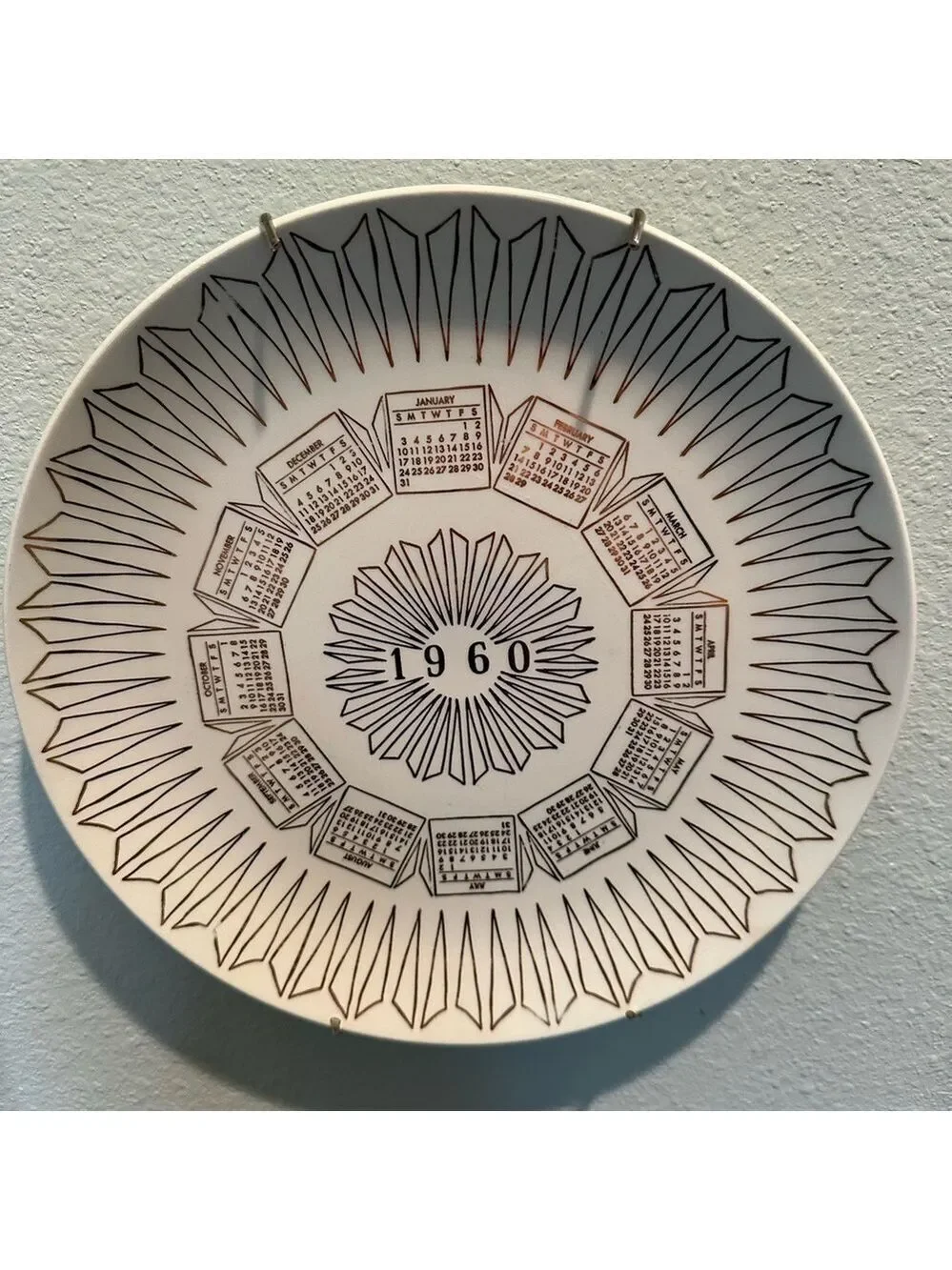 Vintage 1960 Calendar plate. Excellent shape. Wall hanger included. White + Gold
